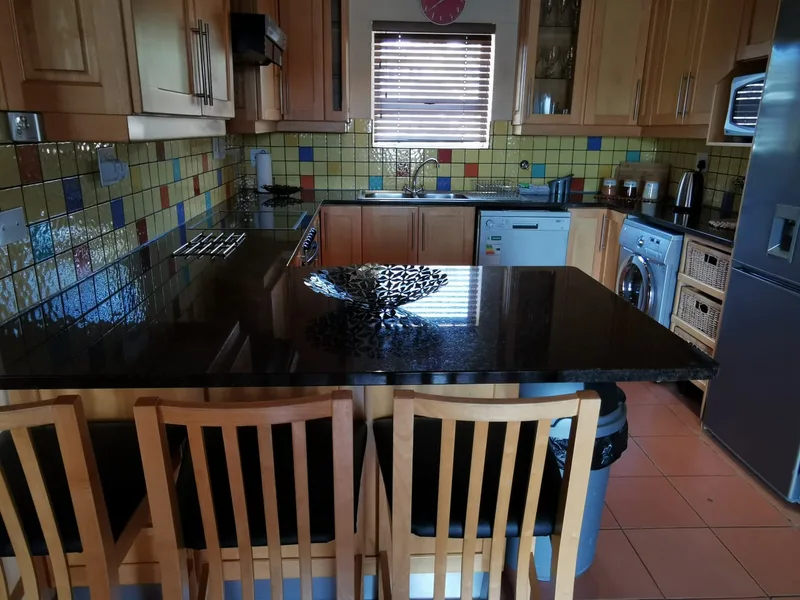 Full chef kitchen with light wood breakfast bar