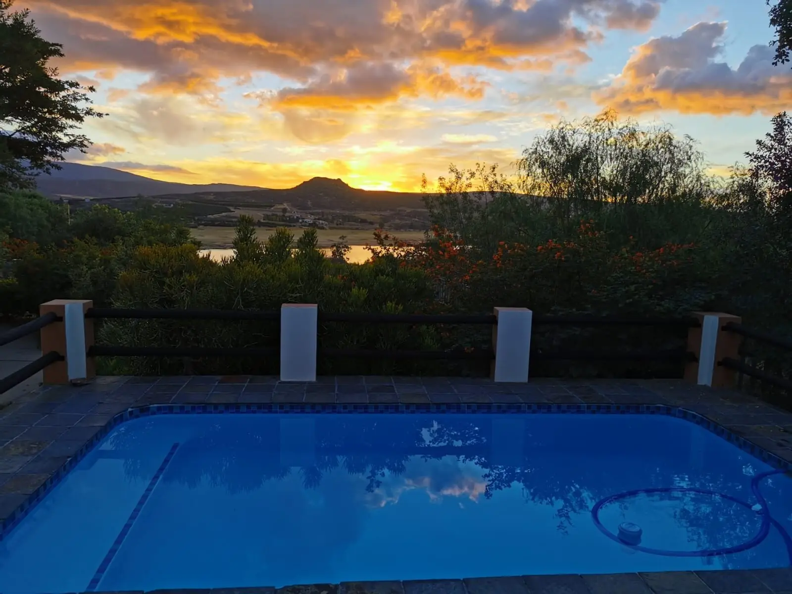 Panoramic sunset over the Clanwilliam Dam seen from the private pool deck